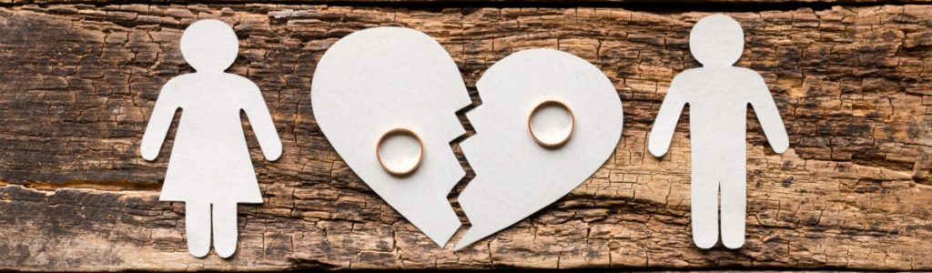 paper family near a broken heart a divorce on a wooden background
